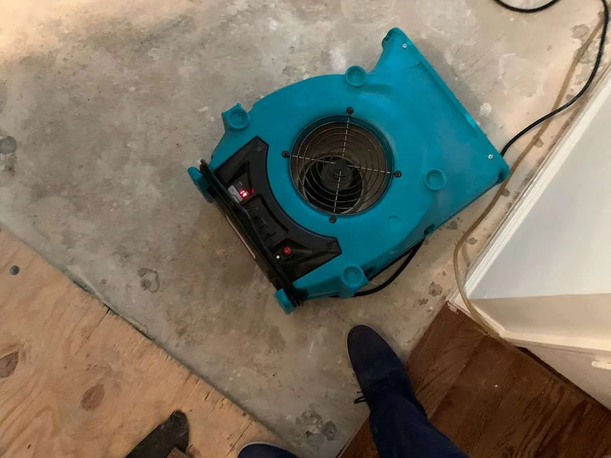 Air mover drying subfloor during Commercial Water Damage Restoration in Holdrege